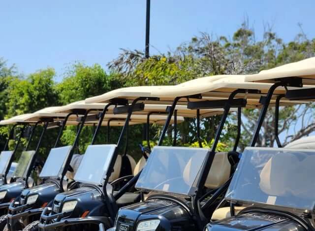 Row of EZCARTS rental golf carts