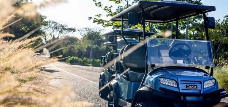 Club Car golf carts parked on a road in Punta Mita